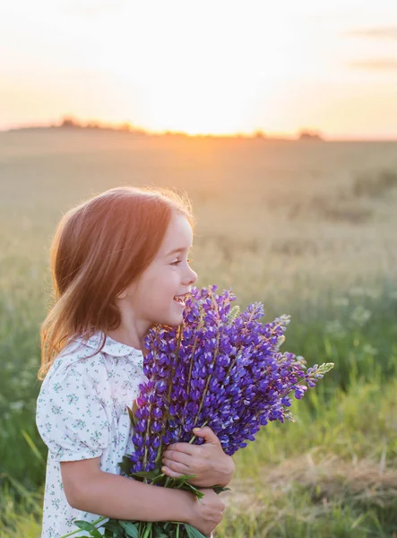 Krásná Holčička Kyticí Květin Při Západu Slunce — Stock fotografie