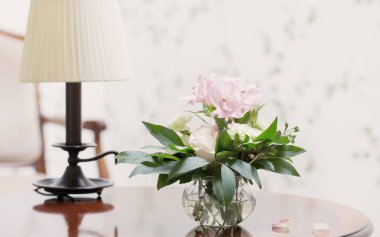 Şarabın içindeki cam vazoda narin bir buket.