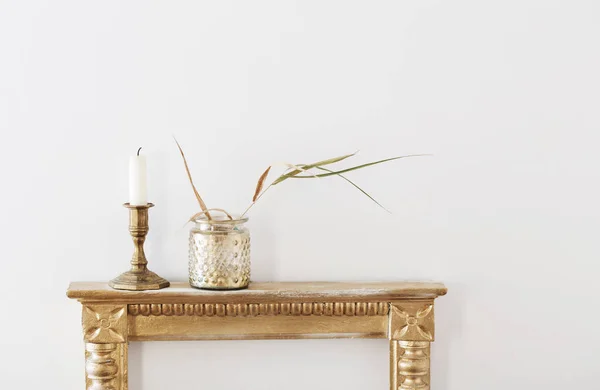在白色背景的旧架子上的金罐子里晒干的植物 — 图库照片