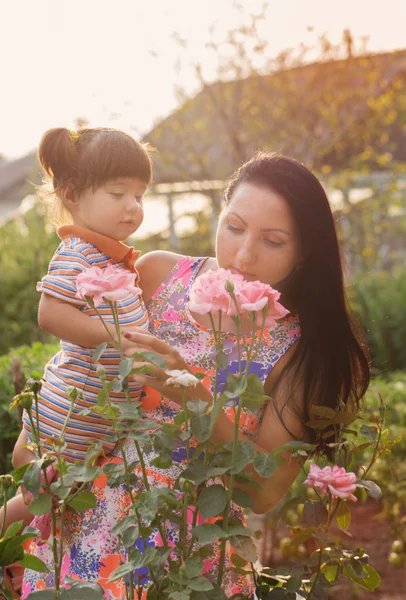 快乐的女人和小孩与室外的玫瑰 — 图库照片