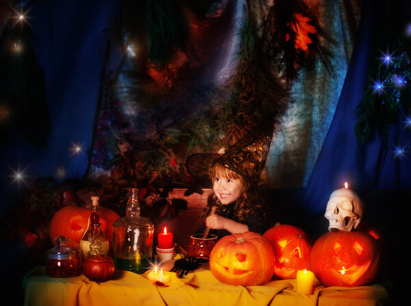 Happy little witch with pumpkin lantern