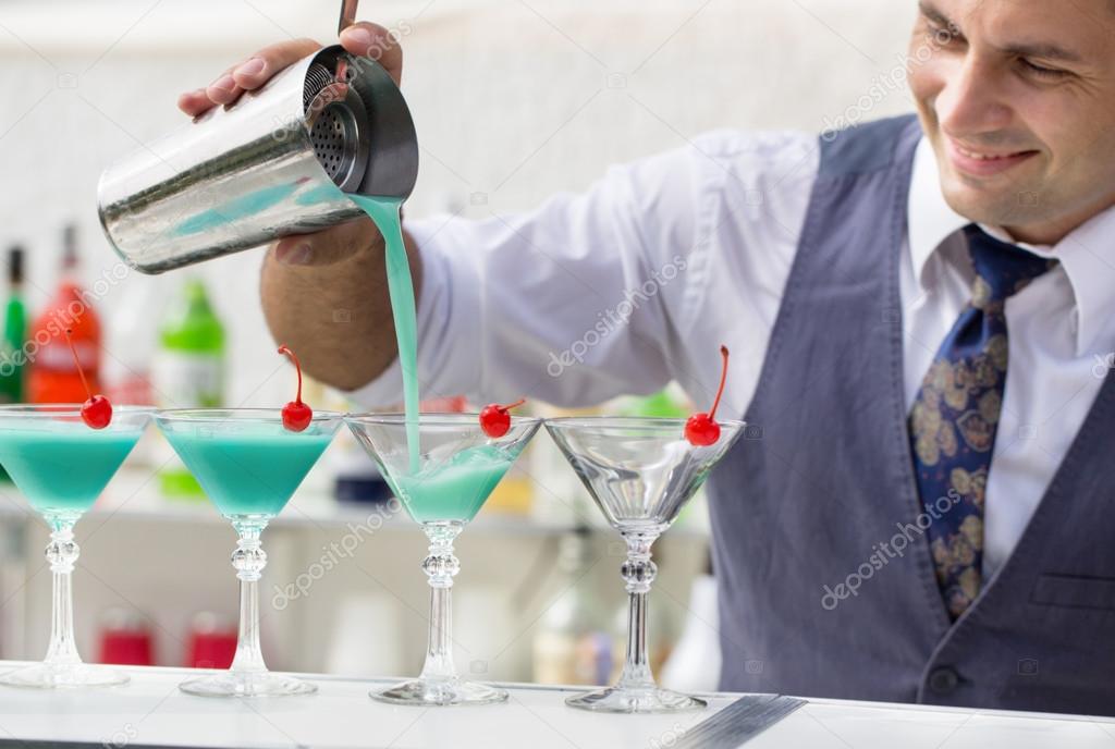 barman pouring a cocktail drink