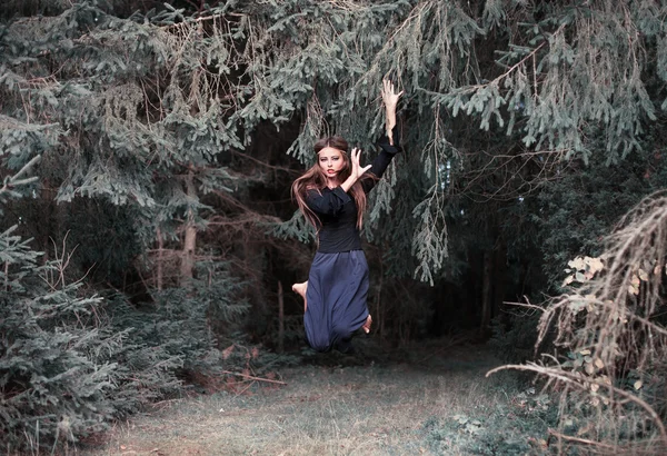 Beautiful witch in forest — Stock Photo, Image