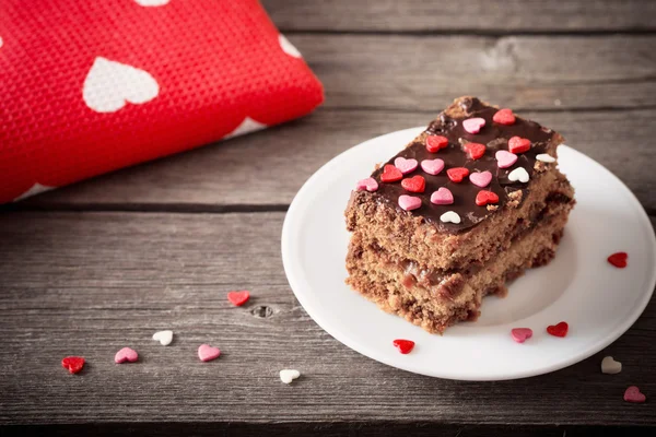 Cake with hearts on wooden background — Stock Photo, Image