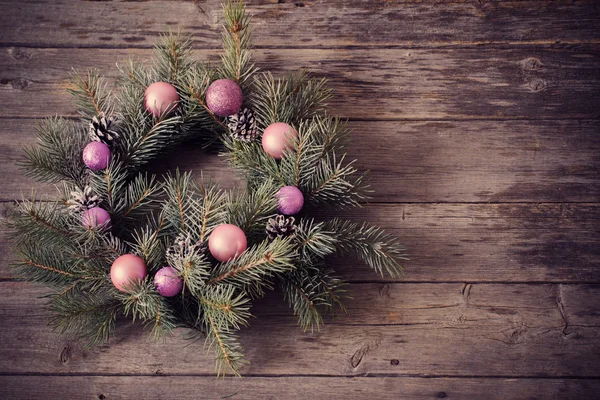 Christmas wreath on a rustic wooden background — Stock Photo, Image