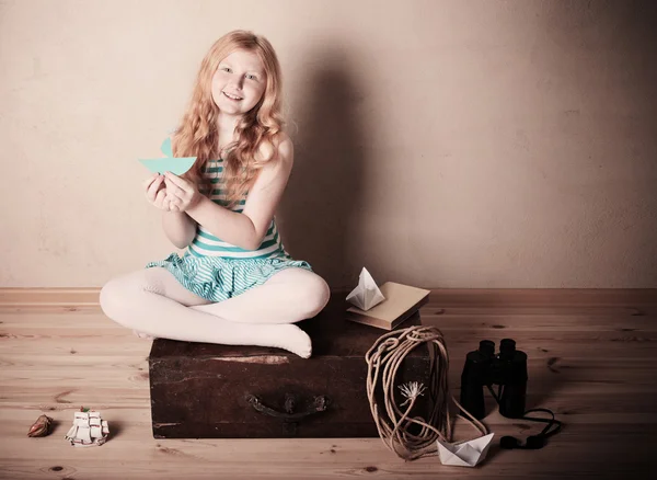 Happy girl playing with toy sailing boat indoors — Stock Photo, Image