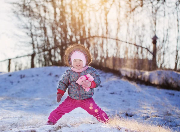 Happy baby girl on snow — Stock Photo, Image