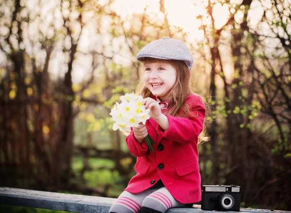 Funny girl on bench in spring park — Stock Photo, Image