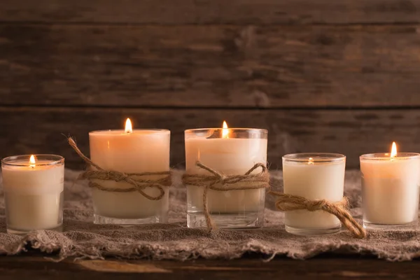 Scented candles on old wooden background Royalty Free Stock Images