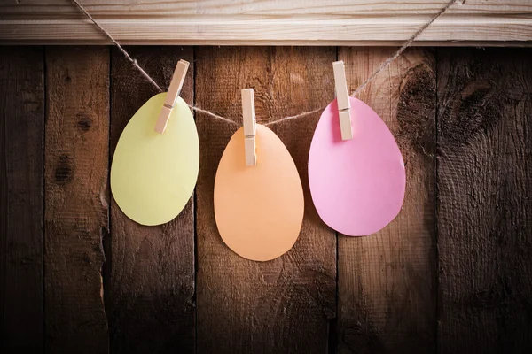 Paper Easter eggs on wooden background — Stock Photo, Image