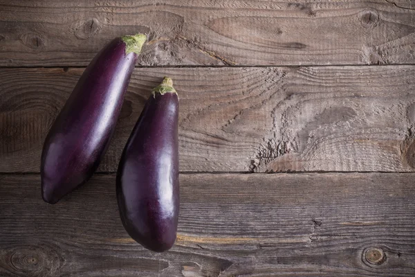 Premium Photo  Scarlet eggplant on a wooden board and wooden background