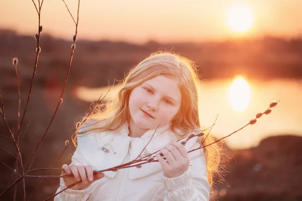 Blond girl with willow on sunset — Stock Photo, Image