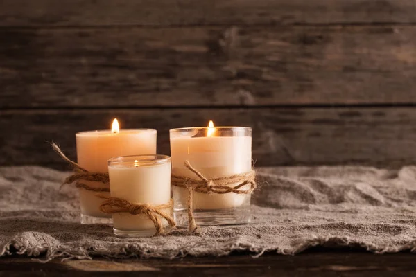 Scented candles on old wooden background — Stock Photo, Image