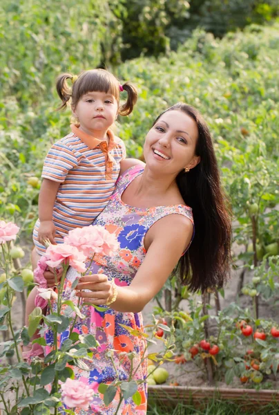 Mutlu kadın ve küçük çocuk bahçesinde — Stok fotoğraf
