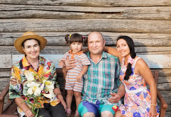 Happy family on background wooden wall — Stock Photo, Image