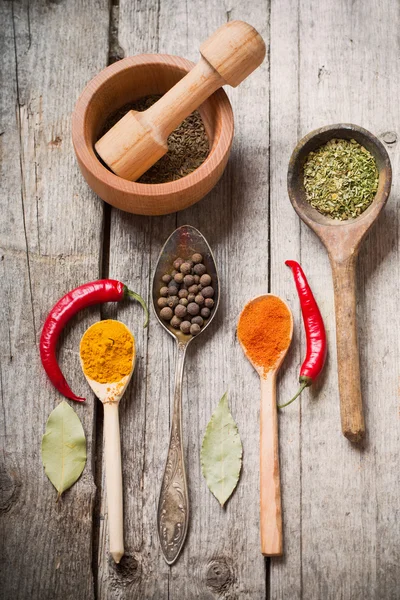 Colorful spices on a wooden background — Stock Photo, Image