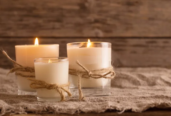 scented candles on old wooden background