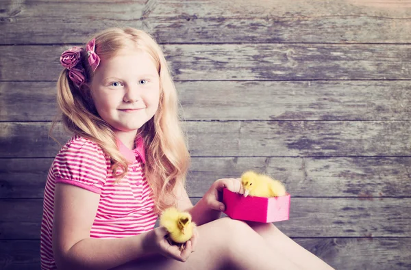 Meisje met gosling op houten achtergrond — Stockfoto