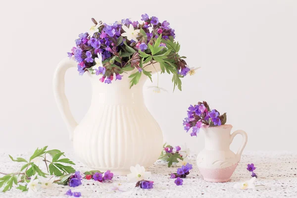 Bouquet of spring flowers in a jug — Stock Photo, Image