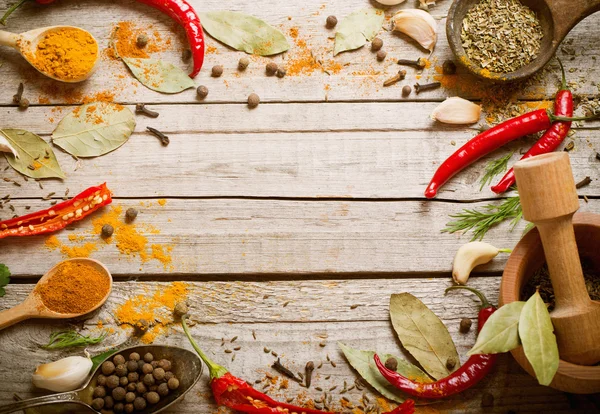 Colorful spices on a wooden background — Stock Photo, Image