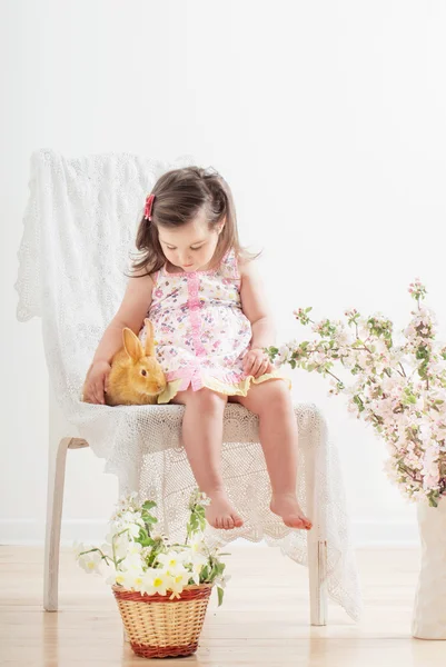 Little girl with rabbit indoor — Stock Photo, Image