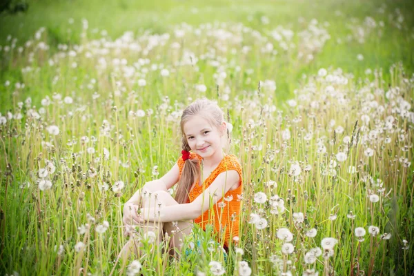 Beautiful girl with dandelions — Stock Photo, Image