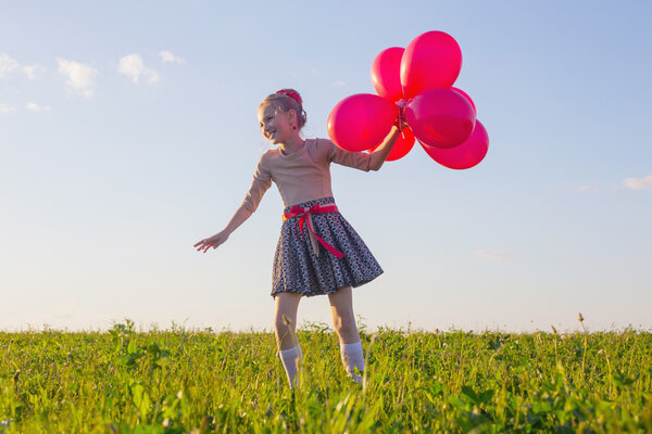 happy girl with red balloons outdoor