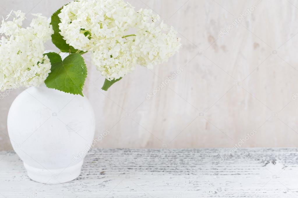 hydrangea in white vase on grunge background