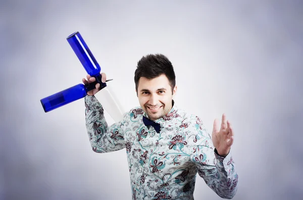 Barman holding shaker and blue bottle — Stock Photo, Image