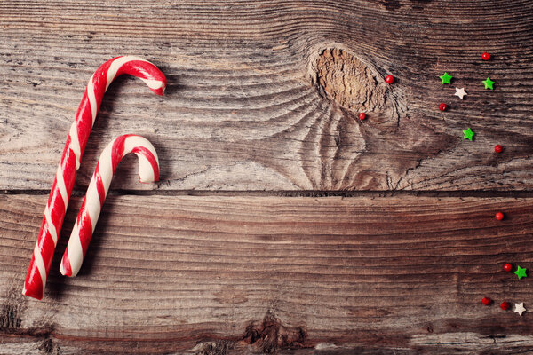 candy canes on weathered wooden board
