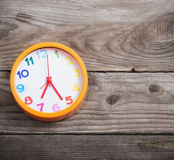 Modern alarm clock with colorful number on wooden background — Stock Photo, Image