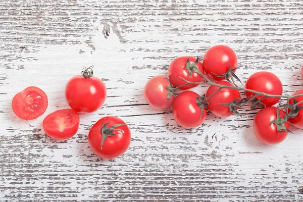 Cherry tomatoes on rustic wooden background — Stock Photo, Image