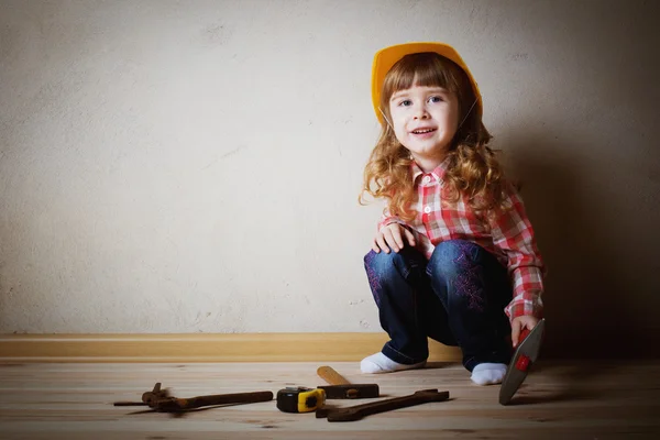 Little girl plays in the builder — Stock Photo, Image