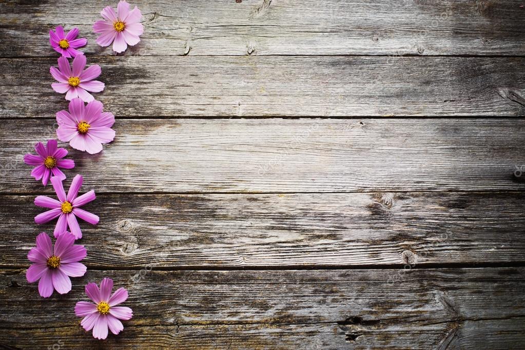 Flowers on wooden background Stock Photo by ©Kruchenkova 83876670