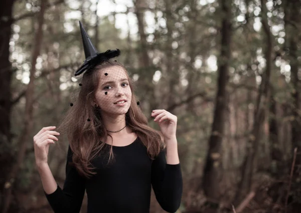 Young witch in forest — Stock Photo, Image