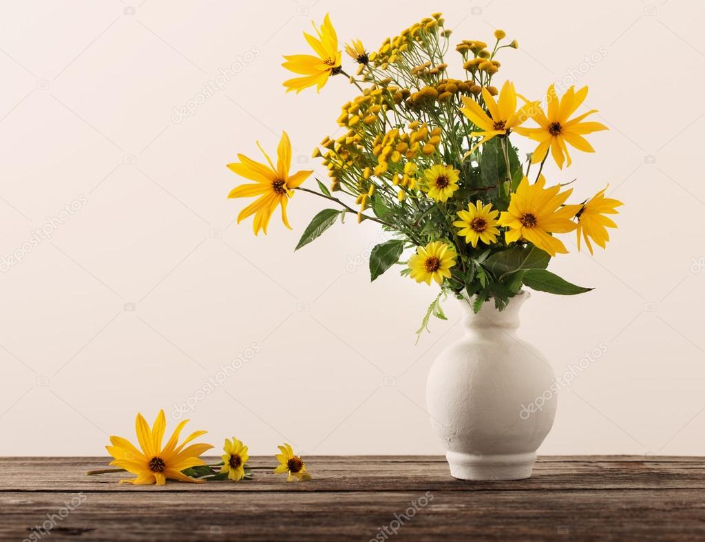 flowers in vase on wooden table