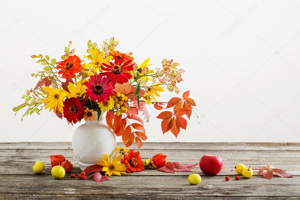 Still life with a autumn flowers and leaves