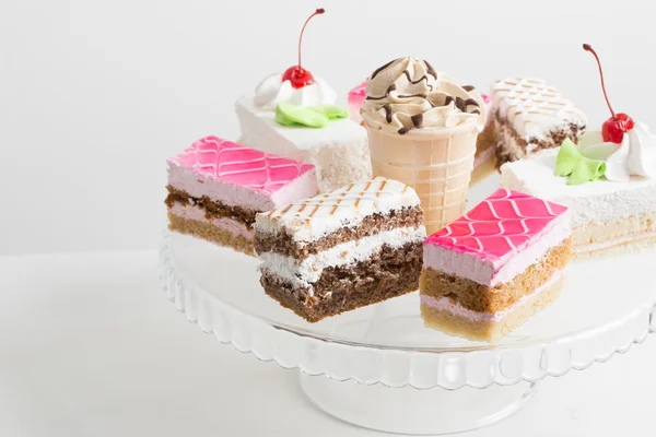 Cakes on white table — Stock Photo, Image