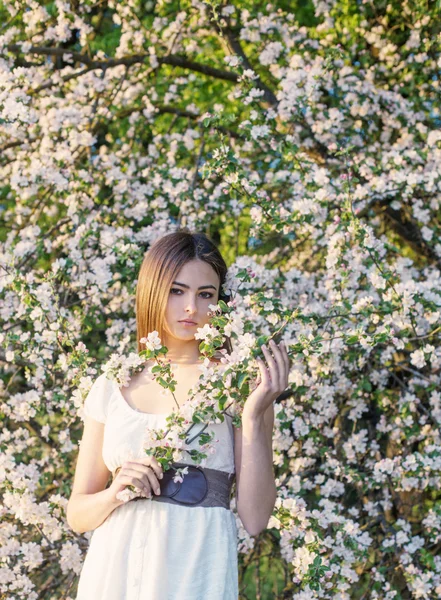 Όμορφη νεαρή κοπέλα σε φόντο ανθίζοντας δέντρο μηλιάς — Φωτογραφία Αρχείου