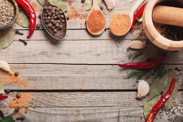 Colorful spices on a wooden background — Stock Photo, Image