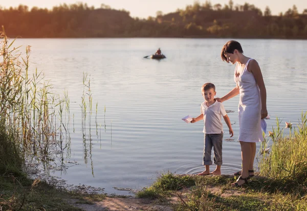 Mother and son on river — Stock Photo, Image