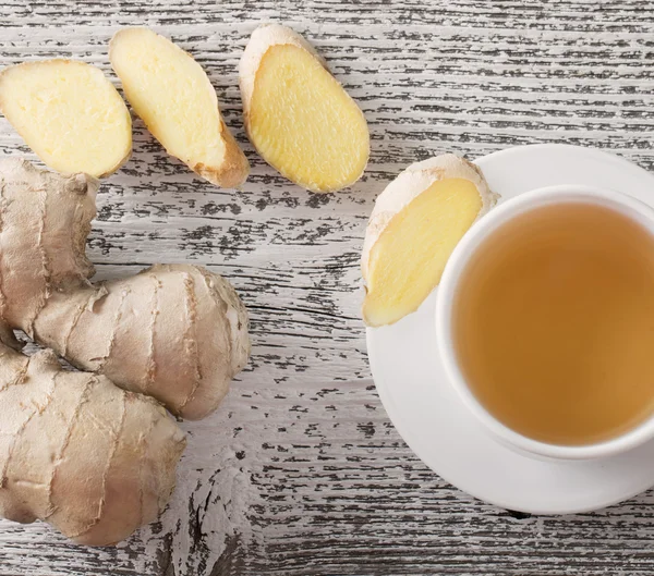 Ginger tea in a white cup on wooden background — Stock Photo, Image