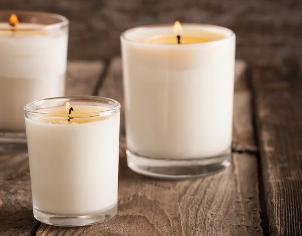 Scented candles on old wooden background — Stock Photo, Image