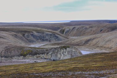 Scarce landscape of cold Arctic desert. Novaya Zemlya archipelago. Nuclear testing range 2 clipart