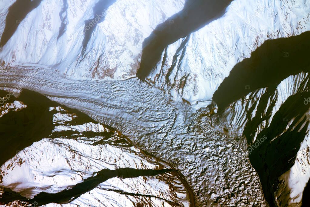 Bright spring of grief with the bird's eye - brilliant snow-capped peaks, deep gorges and glaciers