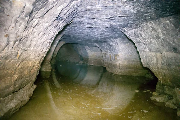 partially flooded underground caves catacomb. journey underground through tunnels