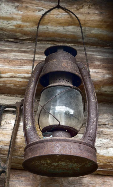 Everyday objects in the Museum and the abandoned old houses. Old kerosene lamp (hurricane lantern) for movement on street. Against wall of log house, old village life