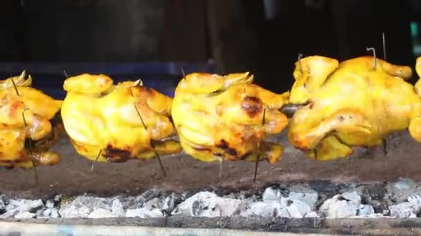 Whole chickens are roasted on a spit — Video