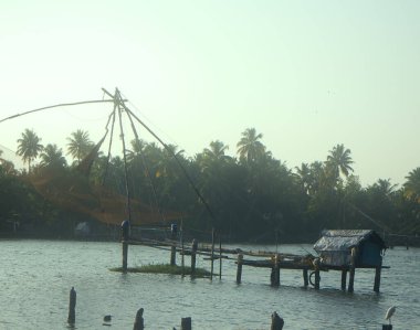 Exotic Indian fishing. Raised fishnet-spider (lift net) on river.