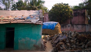 Zavallı Hint evi. Kızılderili taş ocağında üretilen yeni bir ev inşa edecek. Arka planda saman yığını